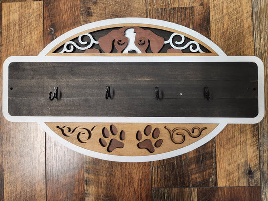 Decorative wall hook with dog design on a wooden background