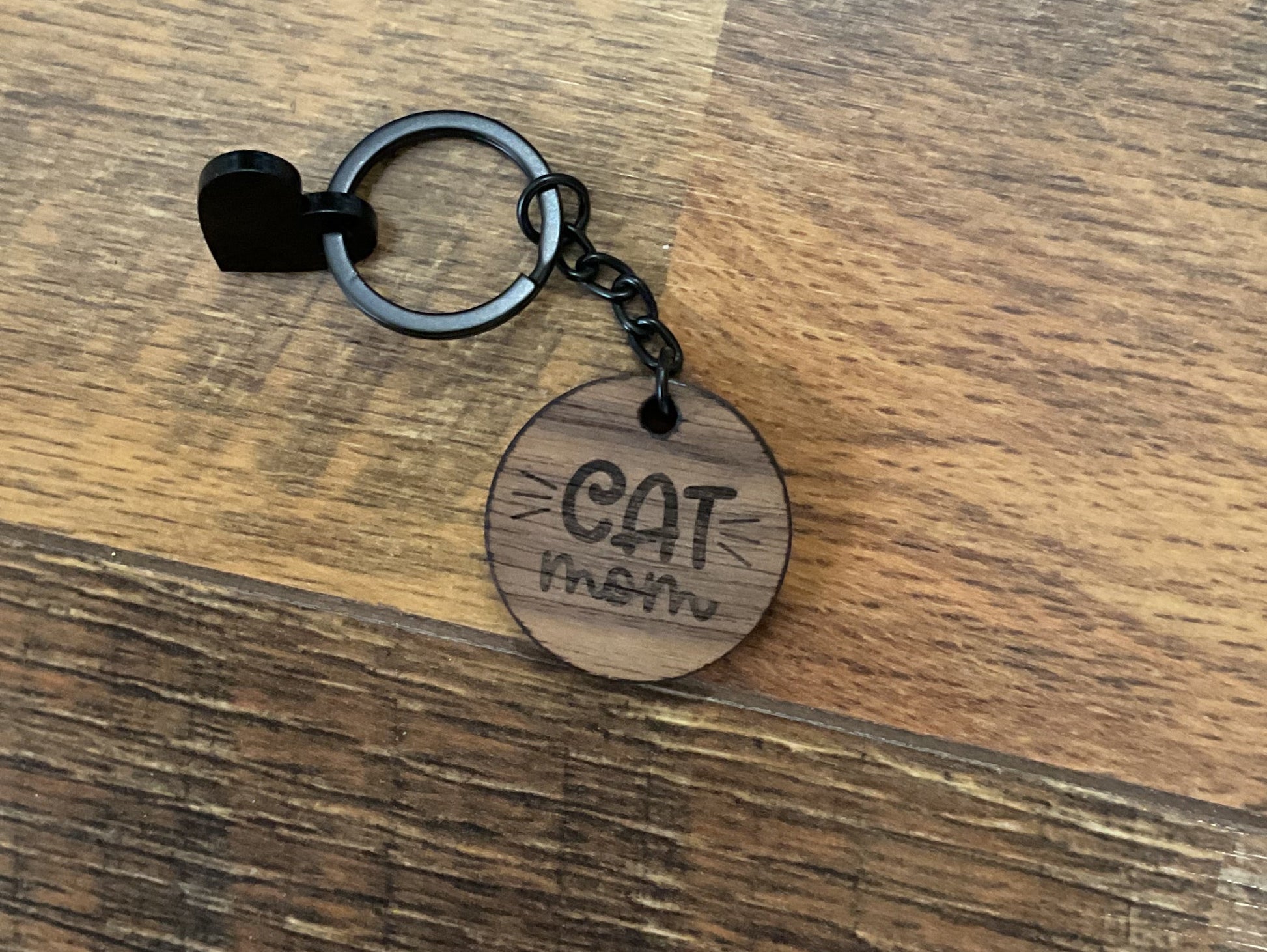 Keychain with a wooden tag on a wooden surface